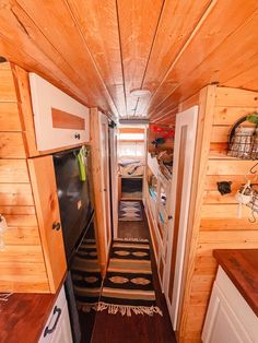 the interior of a tiny cabin with wood paneling