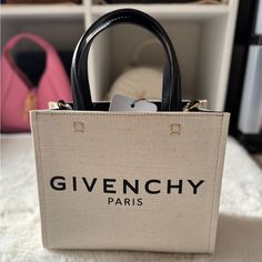 Hi, I’m Selling This Beautiful Givenchy G-Tote Mini Shopping Bag In Canvas, Brand New With Tag. Bought It From Department Store Retail Price $1,250+ Tax. This Is Your Must Have For Your Next Outing Bag! Super Versatile Bag Can Wear It Multi-Ways: Cross Body, Shoulder, Hand Carried With Top Handles. It Can Dress Up Or Down. 100% Authentic. Details: Mini G Tote Shopping Bag In Canvas. Tote Bag In Cotton Canvas And Linen To Be Carried By Hand Black Givenchy Paris Signature Printed On The Front Wide Givenchy Mini Tote Bag, Luxury Medium Bags For Errands, Luxury Medium Bag For Errands, Designer Medium Box Bag With Detachable Handle, Luxury Medium Box Bag With Top Carry Handle, Medium Luxury Beige Bags, Medium Box Bag With Detachable Handle For Shopping, Shopping Box Bag With Detachable Handle, Luxury Medium Beige Bags