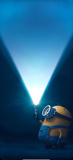 a minion holding a flashlight in front of a blue background with two spotlights