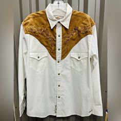 Western Shirt With Suede-Look Shoulder Trim And Embroidery. With Patch Chest Pockets And Snaps. Fabric: 65% Polyester - 35% Viscose/Trim - 100% Polyester White Long Sleeve Shirt For Rodeo, White Long Sleeve Western Top, Western White Tops For Rodeo, White Shirt For Rodeo In Spring, White Long Sleeve Western Shirt, White Fitted Top For Rodeo, Western Style White Embroidered Top, Western Style White Shirt For Spring, White Western Shirt For Spring