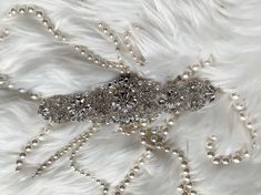 Absolutely Dazzling Finest Crystal Rhinestone & Pearl belt will take your breath away!Made with clear crystals with silver. Great to sewn onto your dress directly . Measurement :2.5 " widest point and 17" long  There is 3 yards long ribbon sash sewn underneath. Please contact us if you need to extend the crystal design .  Double face satin ribbon colors are available in White, Off White, Ivory, Silver, Royal Blue, Navy & Black.  If you want a different ribbon color, please convo me and I will source it for you.  Satin Ribbon/Sash Color - *Please specify the ribbon color of your choice during check out in the "NOTE" section. If I don't see any color name specified in the note section, Thank you for stopping by & Congratulations! :-) Elegant Silver Bedazzled Sash, Elegant Silver Bedazzled Sashes, Elegant Bedazzled Silver Sash, Elegant Bedazzled Silver Sashes, Elegant Silver Belt With Rhinestones, Silver Adjustable Belt With Rhinestones, Adjustable Silver Belt With Bling, Silver Bedazzled Bridal Belt For Wedding, Adjustable Silver Belts With Bling