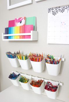 the wall is filled with different colored pencils and markers