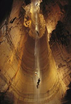 two people standing in the middle of a cave