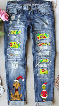 a pair of jeans with patches on them sitting next to a flower and other items