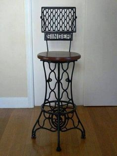 an iron and wood bar stool made from recycled sewing machine parts is on sale at re - escape com