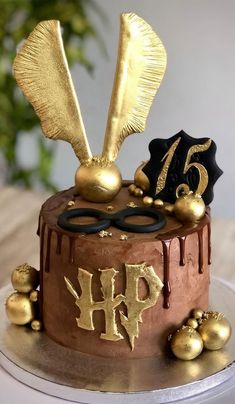 a chocolate cake with gold decorations on top