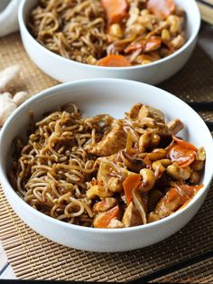 two white bowls filled with noodles and meat