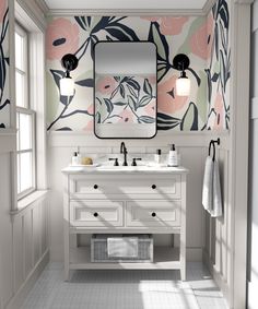 a bathroom with floral wallpaper and two sinks under a large mirror on the wall