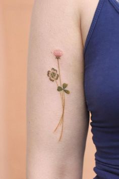 a woman with a flower tattoo on her arm