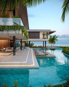 an outdoor swimming pool with lounge chairs and palm trees in the foreground, overlooking the ocean