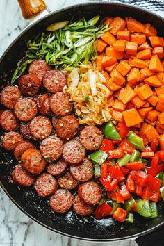 meatballs and vegetables are cooking in a skillet