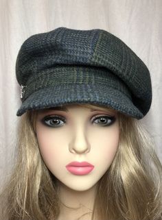 "Stay warm and fashionable in fall and winter with this handmade plaid tweed Newsboy Cap. The alternating blue and green plaid pattern panels add a pop of color to any outfit, while the 100% wool material and tweed fabric type make it perfect for cooler weather. There is a lining of 100% dupioni silk which keeps hair static-free on dry winter days. Included is a rhinestone star-shaped accent pin.  This versatile cap is suitable for travel, casual outings, and workwear. Pack it for your next adve Green Wool Hat For Fall, Blue Flat Cap For Fall, Plaid Cap For Fall, Plaid Wool Hats For Fall, Plaid Short Brim Hat For Winter, Casual Blue Beret For Fall, Winter Plaid Hat With Short Brim, Plaid Wool Hats For Winter, Fall Plaid Wool Hats