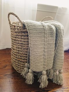 two crocheted baskets sitting on top of a wooden floor