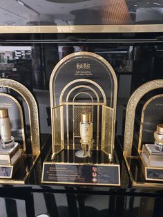 some gold and black items on display in a glass case