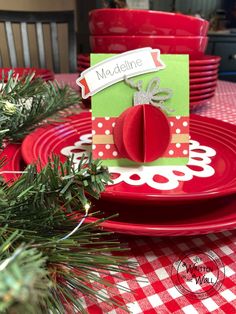 a red plate topped with an apple on top of a table