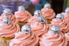 cupcakes with pink frosting and silver decorations