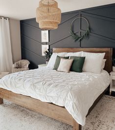 a bed with white sheets and pillows on top of it in a room that has black walls