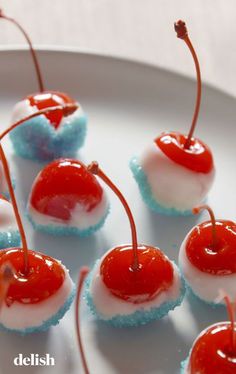 small desserts with cherries and marshmallows are arranged on a plate