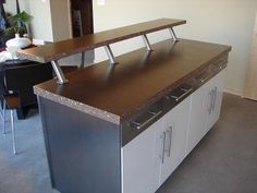 a kitchen island with two sinks and cabinets