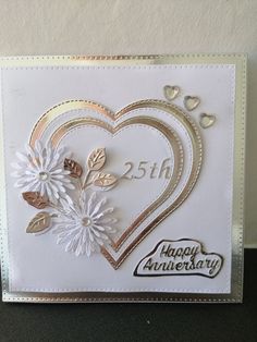 an anniversary card with flowers and hearts on it