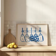 a kitchen counter with lemons and an art print on it