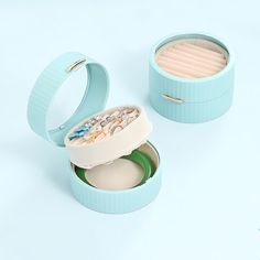 two small blue boxes with various items in them