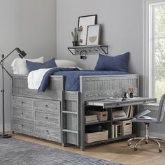 a bedroom with a bed, desk and chair next to a window in the room