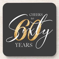 cheers to sixty years coaster with gold glitter on black background and white lettering that reads cheers to sixty years