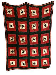 a red and black crocheted afghan with squares on it's sides, in the shape of a square