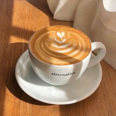 a cappuccino on a saucer with the word alternative written in it