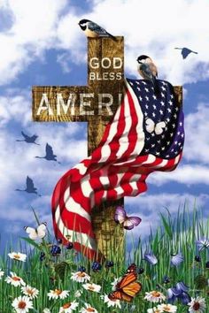 a cross with an american flag draped over it and birds flying in the sky above