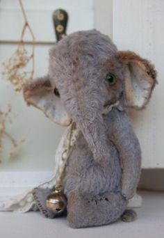 an elephant stuffed animal sitting on top of a table