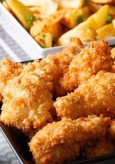 fried chicken wings in a black tray next to other food on a table with text overlay that reads delicious chicken wings