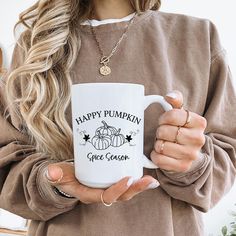 a woman holding a white coffee mug with the words happy pumpkin girl class on it