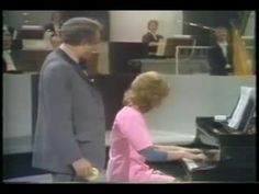 a man and woman are playing the piano