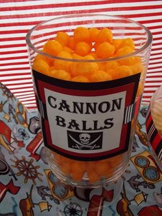 a glass bowl filled with candies on top of a table