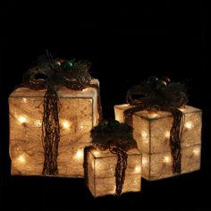 three wrapped presents with lights on them