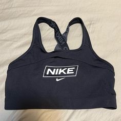 Black Nike Sports Bra With A Crisscross Back. Never Worn Black Go-dry Sports Bra, Black Gym Sports Bra, Black Go-dry Sports Bra For Sports Events, Black Sports Bra For Sports Season, Black Sports Bra For Sports, Black Sporty Sports Bra For Running, Black Sports Bra For Sports Events, Sporty Black Sports Bra For Running, Black Letter Print Activewear For Workout