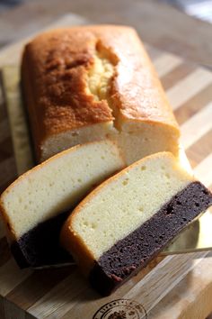 a loaf of cake sitting on top of a wooden cutting board