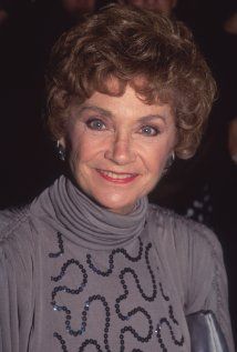 an older woman is smiling for the camera while wearing a turtle neck sweater with sequins on it