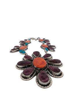 New Native American handmade vibrant colorful squash blossom with purple and orange spiny oyster shell by Navajo artist Kira BlanchardIntroducing this vibrant and colorful squash blossom necklace, handmade by Navajo artist Kira Blanchard. This stunning piece features a striking combination of purple and orange spiny oyster shell, set in a traditional squash blossom design. The intricate craftsmanship and bold colors make this necklace a true statement piece, reflecting the rich cultural heritage and artistry of Navajo jewelry. Perfect for those who appreciate unique, handcrafted Native American pieces, this squash blossom necklace is both a work of art and a wearable expression of Navajo tradition. Whether for special occasions or to add a vibrant touch to your everyday style, this necklac Multicolor Inlay Southwestern Necklace, Bohemian Purple Flower Necklace, Navajo Jewelry, Purple And Orange, Squash Blossom Necklace, Squash Blossom, Blossom Design, Spiny Oyster, Oyster Shell