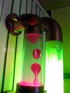 a water faucet is lit up with green and pink lights