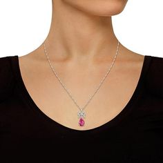 Sterling Silver Pear-Shaped Pink Topaz and Diamond Pendant with Chain Topped with a glittering, diamond-studded bow, this pretty pear-shaped pink topaz pendant will add a touch of classic style to any outfit. Comes with a sterling silver Singapore chain necklace Pendant approx. 1-1/4"L x 1/2"W; chain approx. 18"L x 1/16"W Stamped .925 sterling silver; rhodium plating Pendant: articulated bail; Chain: lobster claw clasp Pendant has prong-set, pear-shaped pink topaz suspended below diamond-studded White Gold Pendant Necklace, Blue Topaz Pendant, White Gold Pendant, Topaz Pendant, White Gold Chains, Garnet Pendant, Halo Pendant, Pink Topaz, Pendant With Chain