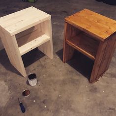 two wooden tables sitting next to each other on top of a cement floor in a garage