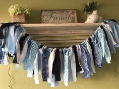 a wooden shelf filled with lots of blue and white ribbon garland on top of it