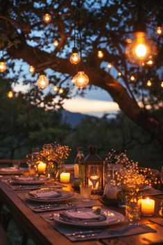 an outdoor dinner table set with candles and place settings