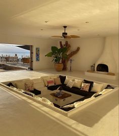 a living room filled with lots of furniture and a fire place in the middle of it