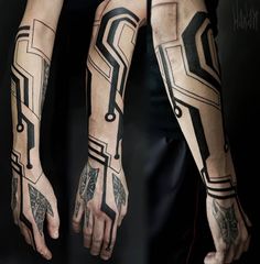 two men's arms with tattoos on them