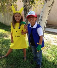 two children dressed up as pokemon and pikachu standing next to each other in the grass