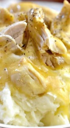 closeup of mashed potatoes with chicken and gravy on the top side